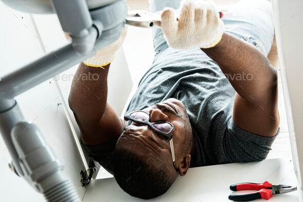 plumber performing sink repair