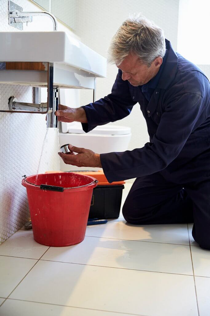 plumber performing sink repair