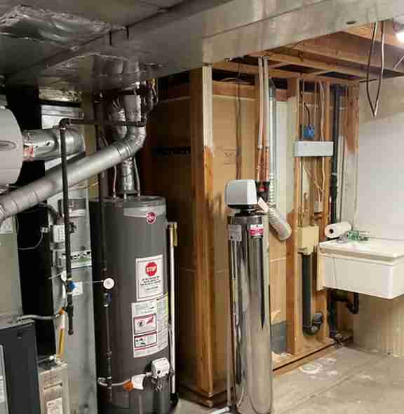 Residential water heater installation in a utility room, showcasing efficient plumbing solutions in Los Angeles.